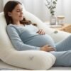 Pregnant woman resting on an organic hypoallergenic pregnancy pillow for added support and comfort