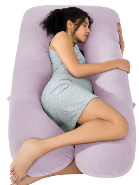 Purple U-shaped pregnancy pillow supporting belly, back, and legs for comfortable sleep